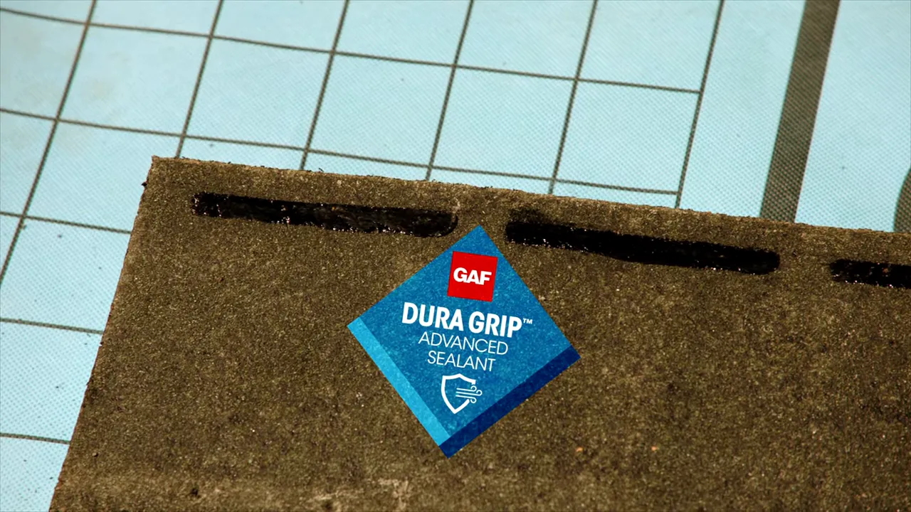 Close-up of GAF DuraGrip sealant showing adhesive placement on a shingle.